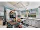 Bright eat-in kitchen with island, modern appliances, white cabinetry, and a cheerful window showcasing backyard views at 291 Folsom Glade Rd, Rydal, GA 30171