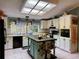 Bright kitchen with an island, tile floors, decorative accents, and modern appliances at 291 Folsom Glade Rd, Rydal, GA 30171