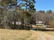 Land with a driveway leading to multiple outbuildings and a wooded area, offering potential for various uses at 291 Folsom Glade Rd, Rydal, GA 30171