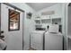 Cozy laundry room with modern washer and dryer set, complemented by farmhouse-style decor and ample storage at 291 Folsom Glade Rd, Rydal, GA 30171