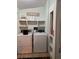 Functional laundry room including a washer, dryer, and shelving space at 291 Folsom Glade Rd, Rydal, GA 30171