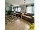 Spacious living room with a large sectional couch, ceiling fan, and natural light at 291 Folsom Glade Rd, Rydal, GA 30171