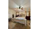 Main bedroom features a decorative bed frame, a ceiling fan, and bright natural light at 291 Folsom Glade Rd, Rydal, GA 30171
