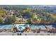 Aerial view of the community pool and tennis courts surrounded by trees at 345 Oakwind Pt, Acworth, GA 30101