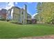 View of the back of the house showing screened-in porch, large windows and backyard at 345 Oakwind Pt, Acworth, GA 30101