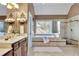 Bright bathroom featuring a soaking tub and separate shower at 345 Oakwind Pt, Acworth, GA 30101
