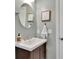 Cozy bathroom with a round mirror and modern vanity at 345 Oakwind Pt, Acworth, GA 30101