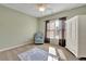 Bedroom with carpet floors, ceiling fan, a view to the backyard and a traditional closet at 345 Oakwind Pt, Acworth, GA 30101