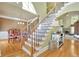 Grand staircase featuring wood treads, iron railings, and lots of natural light at 345 Oakwind Pt, Acworth, GA 30101