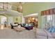 Bright living room featuring hardwood floors, neutral walls, multiple couches, and view to the open kitchen at 345 Oakwind Pt, Acworth, GA 30101