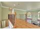 Upstairs hallway shows wood floors, iron railing and view of Gathering room with stone fireplace at 345 Oakwind Pt, Acworth, GA 30101