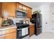 Well-equipped kitchen with stainless steel appliances and wooden cabinetry at 927 Abbey Park Way, Lawrenceville, GA 30044