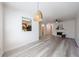 Open-concept living area featuring stylish light fixture, fireplace, and modern gray floors at 927 Abbey Park Way, Lawrenceville, GA 30044