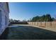 Fenced backyard with a brick home and manicured lawn at 2256 Cadenza Cir, Dacula, GA 30019