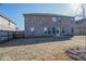 Spacious backyard with a brick home and wooden fence at 2256 Cadenza Cir, Dacula, GA 30019
