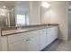 Elegant bathroom featuring double sinks, gray countertops, and ample storage space at 2256 Cadenza Cir, Dacula, GA 30019