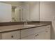 Bright bathroom featuring a modern vanity with a stone countertop and a framed mirror at 2256 Cadenza Cir, Dacula, GA 30019