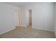 A carpeted bedroom has a door to a closet and another to the hall at 2256 Cadenza Cir, Dacula, GA 30019