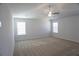 Bright bedroom with neutral carpet, a ceiling fan, and two windows allowing natural light at 2256 Cadenza Cir, Dacula, GA 30019