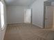 This carpeted bedroom features a window and two doors at 2256 Cadenza Cir, Dacula, GA 30019