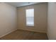 Bright bedroom featuring natural light from the window and plush carpeting at 2256 Cadenza Cir, Dacula, GA 30019