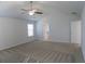 Spacious bedroom featuring neutral carpet, a ceiling fan, and access to an adjoining room at 2256 Cadenza Cir, Dacula, GA 30019