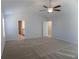 Bright carpeted bedroom featuring neutral walls and a ceiling fan for added comfort at 2256 Cadenza Cir, Dacula, GA 30019