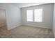 This bedroom has carpeted floors and a window for plenty of natural light at 2256 Cadenza Cir, Dacula, GA 30019