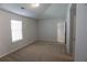 A carpeted bedroom includes a window and a door to the hall at 2256 Cadenza Cir, Dacula, GA 30019