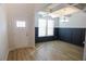 Well-lit dining area with navy wainscoting, coffered ceilings, and wood floors at 2256 Cadenza Cir, Dacula, GA 30019