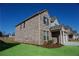 Brick home with an attached three-car garage and well-maintained landscaping at 2256 Cadenza Cir, Dacula, GA 30019