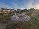 Community firepit with stone surround and Adirondack seating at 2256 Cadenza Cir, Dacula, GA 30019