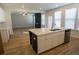 Open concept kitchen showcasing a large kitchen island and stainless steel appliances at 2256 Cadenza Cir, Dacula, GA 30019