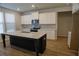 Bright and spacious kitchen with a dark island, stainless appliances and white cabinets at 2256 Cadenza Cir, Dacula, GA 30019