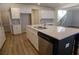 Kitchen island with stainless dishwasher, sink, and white countertops in an open-concept kitchen at 2256 Cadenza Cir, Dacula, GA 30019