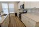 Bright kitchen featuring white cabinets, stainless steel appliances and sleek countertops at 2256 Cadenza Cir, Dacula, GA 30019