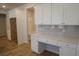 Charming kitchenette area with white cabinetry, desk space, and ample storage at 2256 Cadenza Cir, Dacula, GA 30019