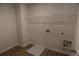 A simple laundry room includes laminate floors and utility connections at 2256 Cadenza Cir, Dacula, GA 30019