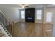 Living room with wood floors, electric fireplace, and lots of natural light at 2256 Cadenza Cir, Dacula, GA 30019