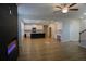 Spacious, open-concept living room with a fireplace, kitchen, and hardwood floors at 2256 Cadenza Cir, Dacula, GA 30019