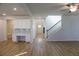 Bright living room featuring wood floors, staircase, and stylish modern lighting at 2256 Cadenza Cir, Dacula, GA 30019