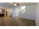 Open concept living room with ceiling fan, staircase, and wood flooring at 2256 Cadenza Cir, Dacula, GA 30019