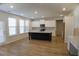 Open floor plan showcasing the kitchen island with stainless steel appliances and lots of natural light at 2256 Cadenza Cir, Dacula, GA 30019