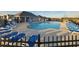 Community pool with lounge chairs and outdoor seating area under a covered patio at 2256 Cadenza Cir, Dacula, GA 30019