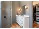 Well-lit bathroom with a vanity, modern fixtures, and a view into the walk-in closet at 28 Cedar Gate Ln, Kingston, GA 30145