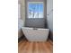 Elegant bathroom with a freestanding tub, sleek faucet, and natural light from the window at 28 Cedar Gate Ln, Kingston, GA 30145