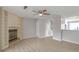 Open-concept living room with fireplace, shelving, modern ceiling fan, and new flooring at 669 Hunting Creek Se Ln, Conyers, GA 30013