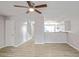 Bright and airy living room featuring a ceiling fan and an open view into the kitchen at 669 Hunting Creek Se Ln, Conyers, GA 30013