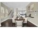 Dining area featuring hardwood floors and view of a modern kitchen with white cabinets at 108 Blakemore Se Dr, Smyrna, GA 30080