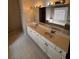 Double sink vanity with white cabinets and tiled floors offer a blend of functionality and style at 136 Hunters Ct, Dallas, GA 30157